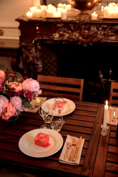 Cutlery plate knife and forks glass on table setting and flowers